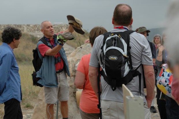 John uses a pile of hats to illustrate how a tell is formed