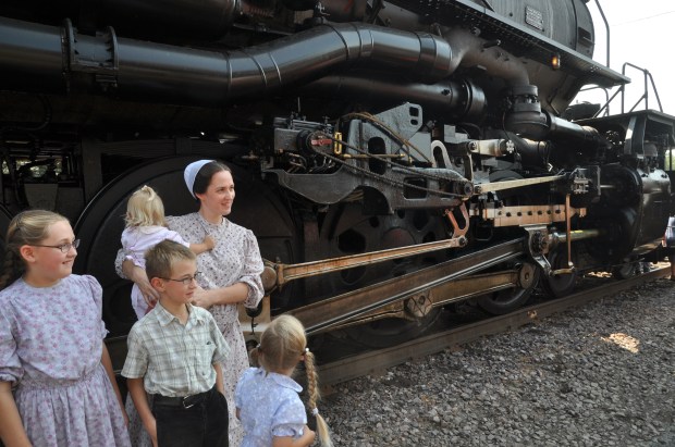 People were getting their pictures taken next to the huge engine.