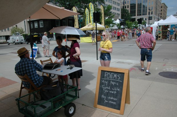 The adjacent Art Fair Off the Square features Wisconsin artists, including an impromptu poet.