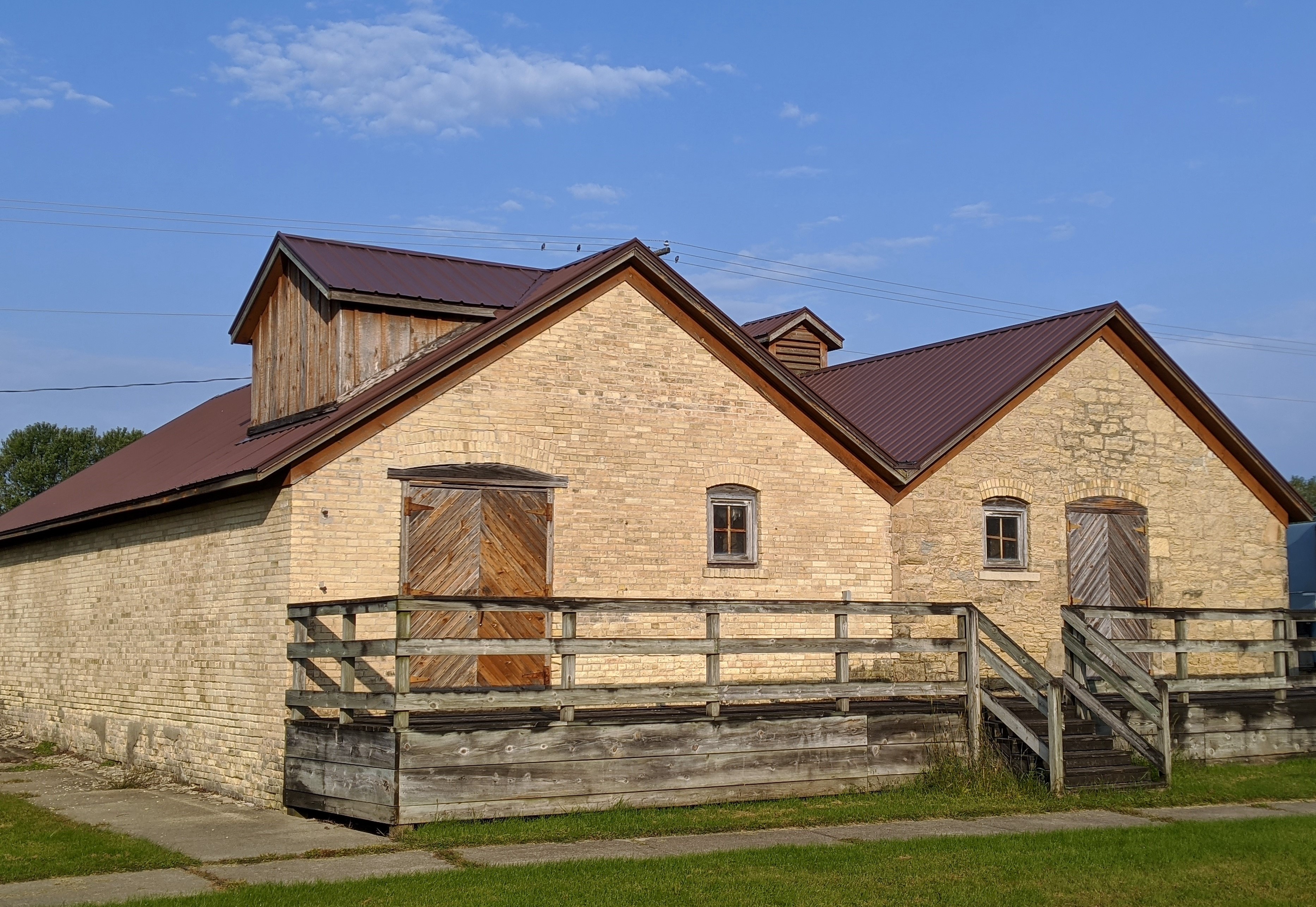 these two buildings look similar except one is built of stone and one is brick.