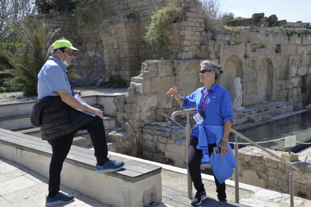 Our other leader, our Israeli guide Shlomo Ben-Asher, conferring with tour member Wanda at the Caesarea Nymphaeum.