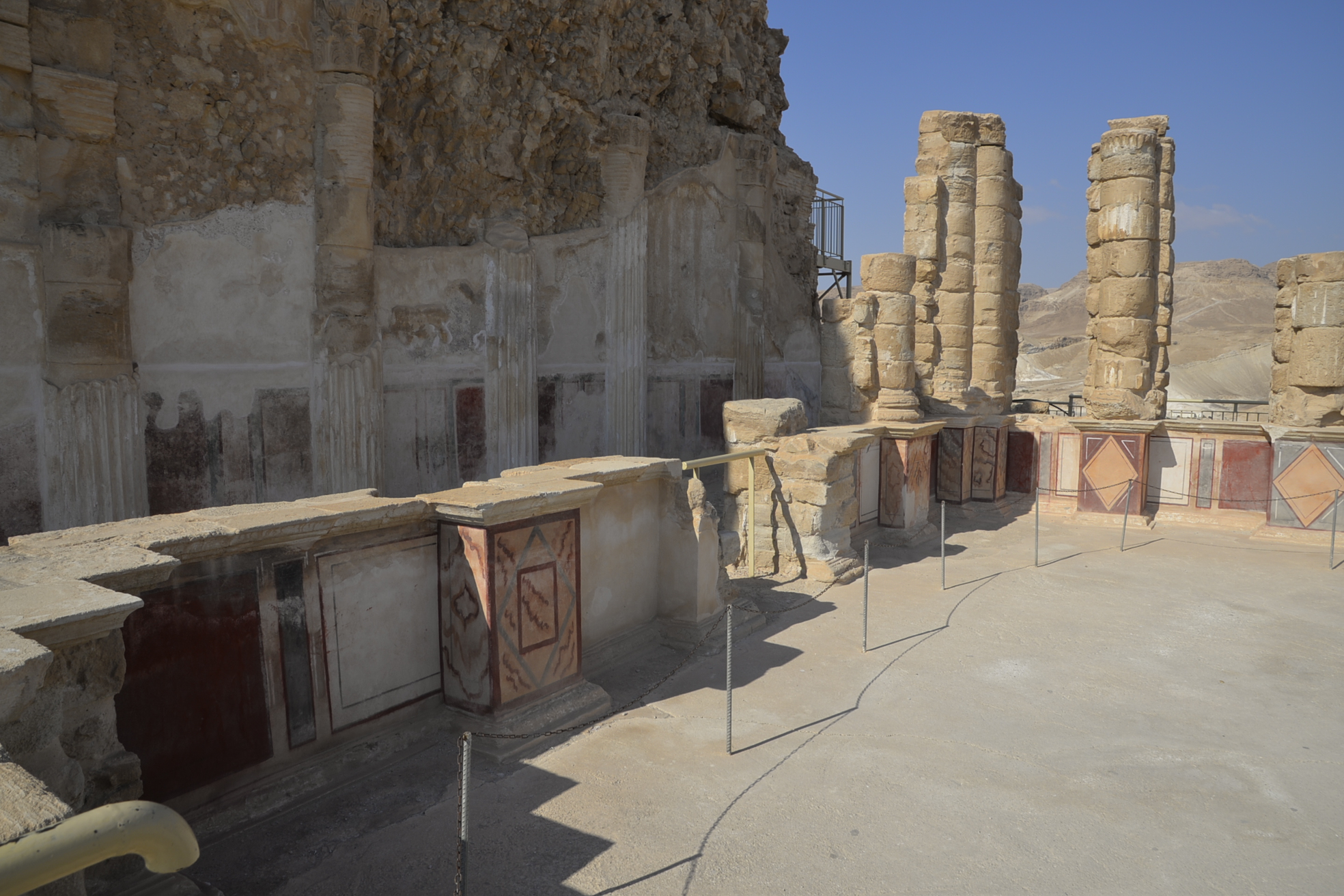 Inside the northern palace, with recreated frescoes along the walls.